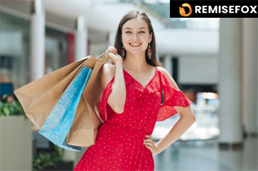 Femme heureuse consultant son ordinateur pour trouver des Codes Promo Exclusifs et bons plans afin d’économiser en 2025